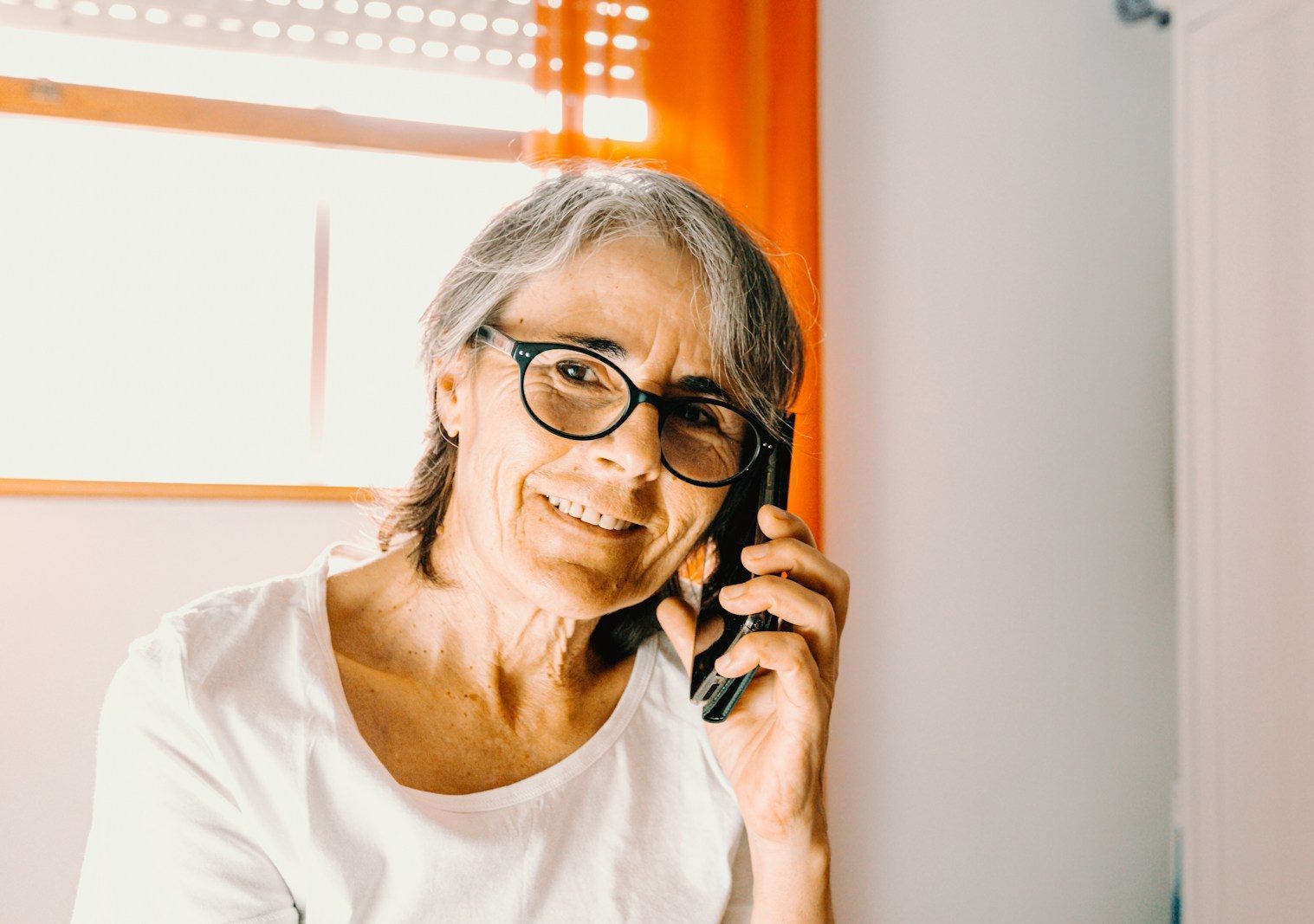 woman in white scoop neck shirt wearing black framed eyeglasses